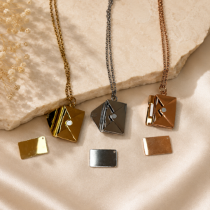 Collier enveloppe personnalisable en métal disponible en or, argent et or rose avec carte intérieure gravée sur mesure.