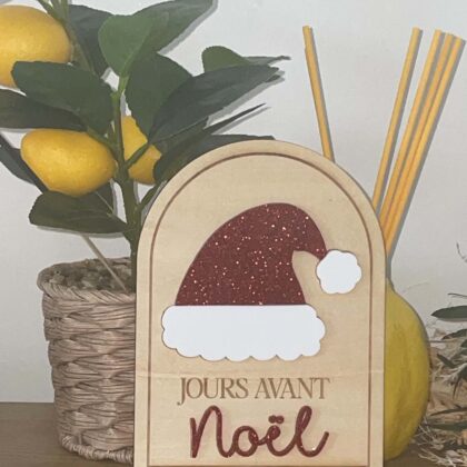 Compteur de jours avant Noël en bois avec bonnet de Père Noël rouge pailleté. Un joli compte à rebours pour faire patienter les enfants jusqu'au 25 décembre.